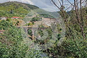 Landscape with arched bridge over the ZÃªzere river in aerial view and BouÃ§Ã£ dam, PORTUGAL photo