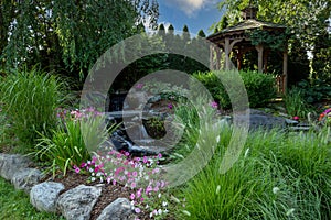 Landscape architecture with water feature and ornamental grass and gazebo