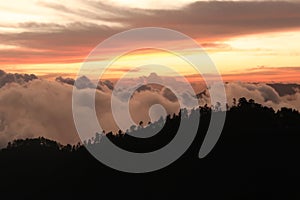 The landscape around San Jose del Pacifico at sunset, clouds, hills and a colorful sky, Oaxaca, Mexico photo