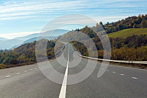 Landscape with asphalt road leading