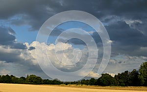 Landscape. Autumn fields. Agrarian country. Golden field. Dark clouds.