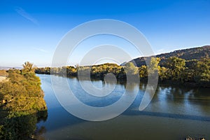 Landscape in the fall season near river photo