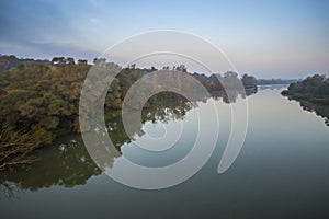 Landscape in the fall season near river photo