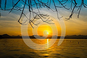 The landscape Background of a golden sunset reflect water and silhouette mountain in west lake xihu in Hangzhou CHINA - Image