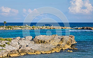 Landscape with balanced rocks, stones on a rocky coral pier. Turquiose blue Caribbean sea water. Riviera Maya, Cancun, Mexico.