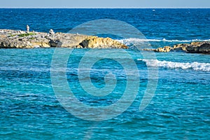 Landscape with balanced rocks, stones on a rocky coral pier. Turquiose blue Caribbean sea water. Riviera Maya, Cancun, Mexico.