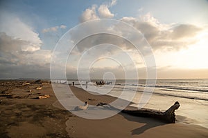 Landscape of a beach at sunset in Barranquilla with fishermen working in the background. Colombia.