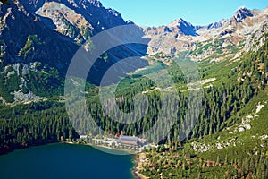 Landscape of the beautiful autumn Poprad lake surrounded by high peaks of Tatra mountains