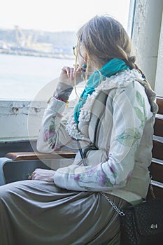 landscape beautiful girl dressed in boho style, riding a ferry in Istanbul