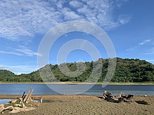 Landscape of beautiful reservoir with blue sky and cracked mud