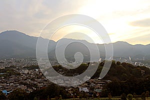 The landscape of Beppu in Oita and golf range as seen from a hill in sunset