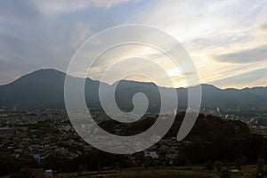 The landscape of Beppu in Oita and golf range as seen from a hill in sunset