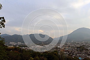 The landscape of Beppu in Oita and golf range as seen from a hill in sunset