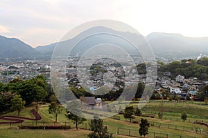 The landscape of Beppu in Oita and golf range as seen from a hill in sunset