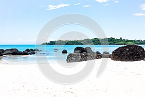 Landscape big dark stone and white sand with blue sky in thailan