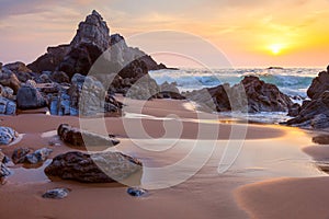 Landscape of big rocks the ocean beach at sundown