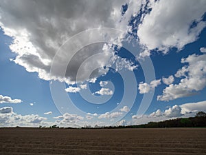 Landscape with big white clouds and blue sky