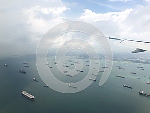 Landscape from bird eye view seascape of dense rows of cargo ship from airplane window.
