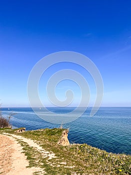 Landscape of blue Baltic sea with white sand and cloudy sky