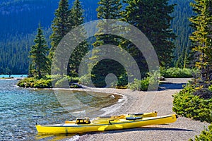 Landscape of blue Hector Lake with canoes in Banff National Park, Canada