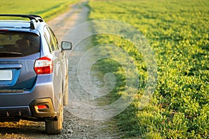 Landscape with blue off road car on gravel road. Traveling by auto, adventure in wildlife, expedition or extreme travel on a SUV