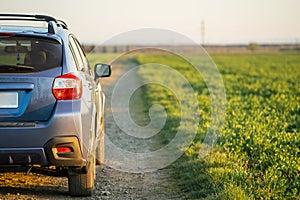 Landscape with blue off road car on gravel road. Traveling by auto, adventure in wildlife, expedition or extreme travel on a SUV