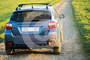 Landscape with blue off road car on gravel road. Traveling by auto, adventure in wildlife, expedition or extreme travel on a SUV