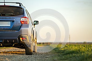 Landscape with blue off road car on gravel road. Traveling by auto, adventure in wildlife, expedition or extreme travel on a SUV