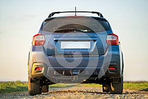 Landscape with blue off road car on gravel road. Traveling by auto, adventure in wildlife, expedition or extreme travel on a SUV