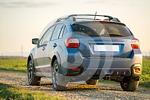 Landscape with blue off road car on gravel road. Traveling by auto, adventure in wildlife, expedition or extreme travel on a SUV