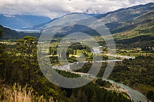 Landscape of Blue river, valley and forest in El Bolson photo