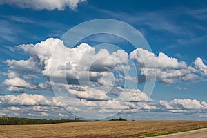 Landscape with Blue sky background and big white tiny stratus cirrus striped clouds