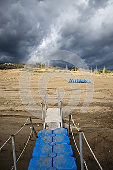 Landscape of blue small pier and blue kayaks on the beach, Congost de Mont Rebei