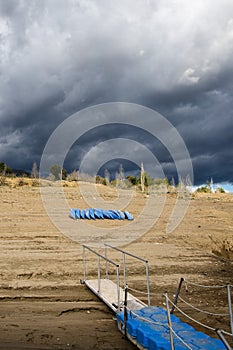 Landscape of blue small pier and blue kayaks on the beach, Congost de Mont Rebei