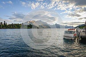 Landscape of boat dock on a lake with beautiful mountain as the background at Queenstown in New Zealand