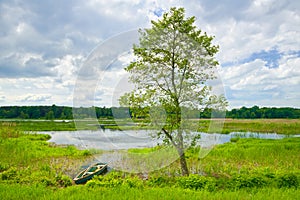 Landscape with boat on the flood waters of Narew river.