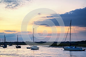 Landscape of boats in harbor during Summer sunset