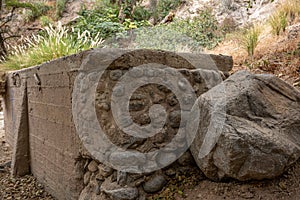 Landscape of boulders at Eaton Canyon hiking trails with wild plants with sunlight