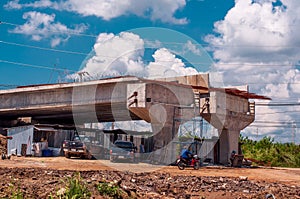 Landscape of building highway bridge over temporary house of workers on the construction site