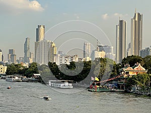 Landscape of buildings river and boats in Thailand