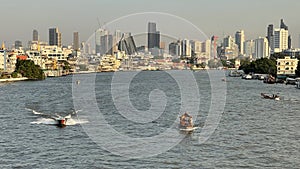 Landscape of buildings river and boats in Thailand