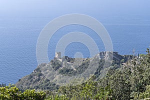 Capo d Uomo old tower and rocky cape on Mediterranean shore, Monte Argentario, Italy photo