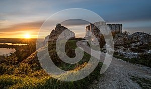 A landscape with the Chateau Gaillard (Saucy Castle) at sunset with the sun in back-light