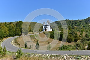 Landscape with church `SfÃÂ¢ntul Nicodim de la Tismana` from Ponoarele, Romania. photo