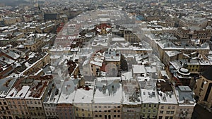 The landscape of the city center of Lviv from the city hall. The roofs are covered with snow.