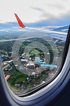 Landscape and city view of window at flying airplane
