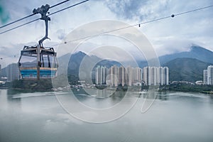 Landscape, cityscape, rainy day, The Building located on the seaside. There are mountains behind the building and a cable car