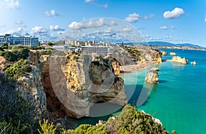 Landscape with cliff, resort and Dona Ana beach at Algarve photo