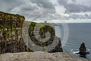 Landscape of the Cliffs of Moher and the Branaunmore sea stack seen from a plateau