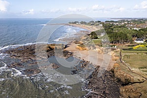Landscape coastline from drone, coast at low tide in France, rocks, ocean and houses